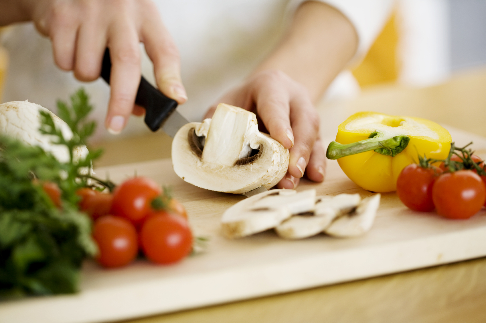 female chopping food ingredients